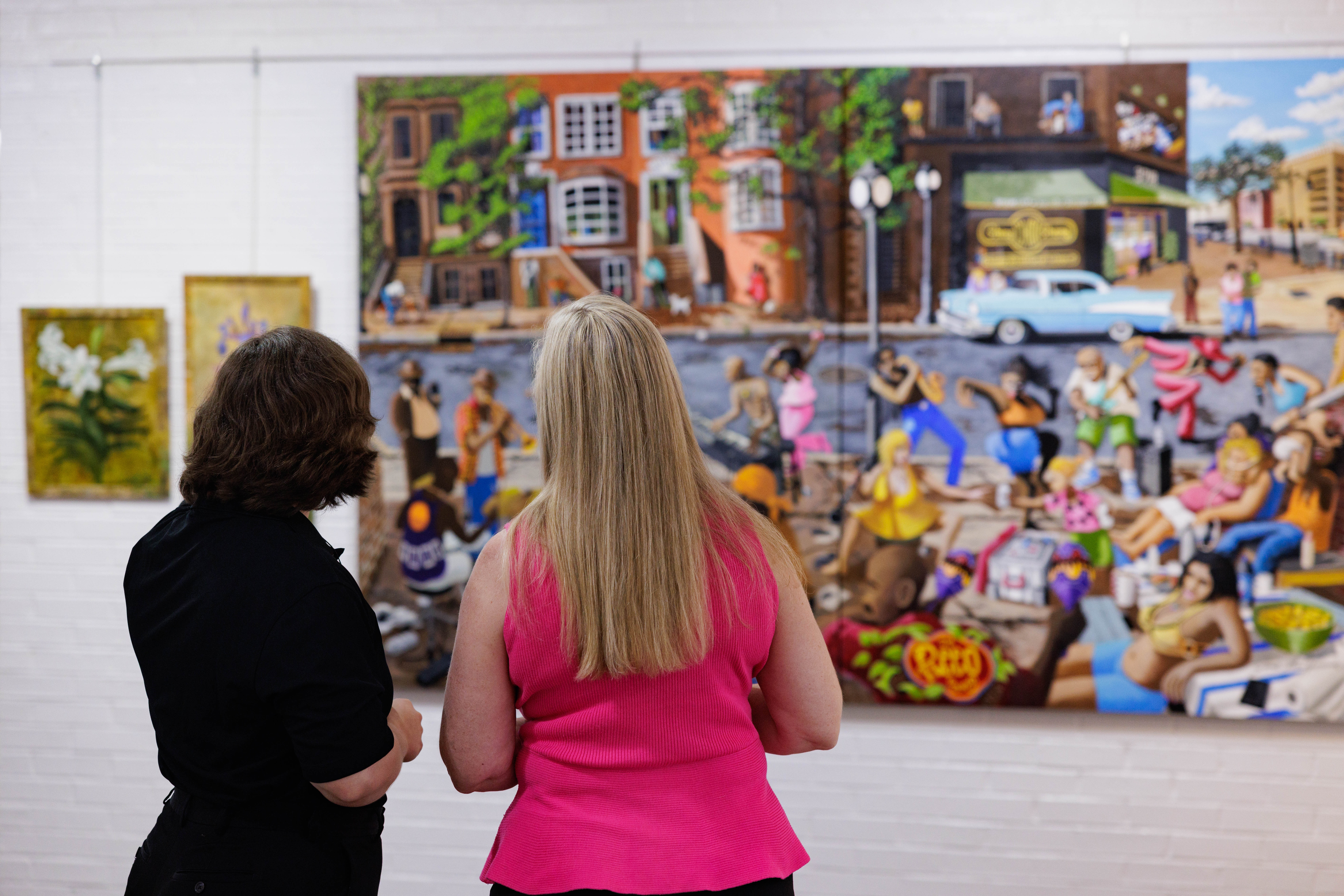 Two people looking at art at the Suffolk Art Gallery in Suffolk, VA